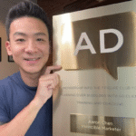 Screenshot of Aaron Chen holding an award 